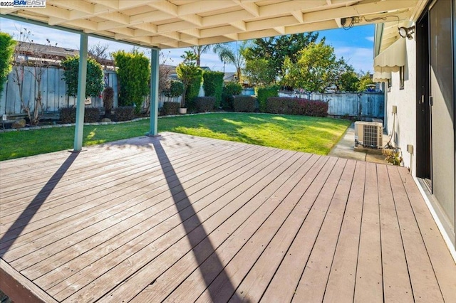 wooden deck featuring central AC unit and a lawn