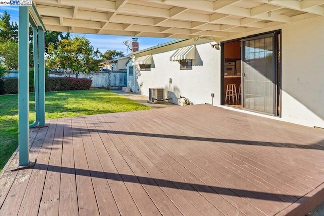 wooden deck featuring central AC unit and a lawn