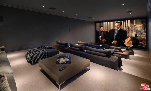 home theater room with crown molding and carpet flooring