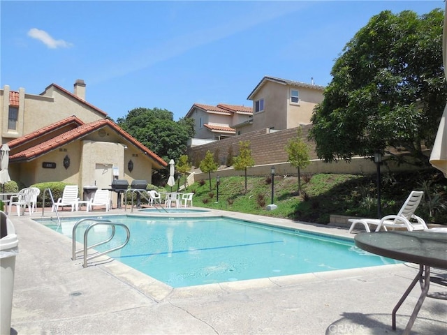 view of swimming pool with a patio area