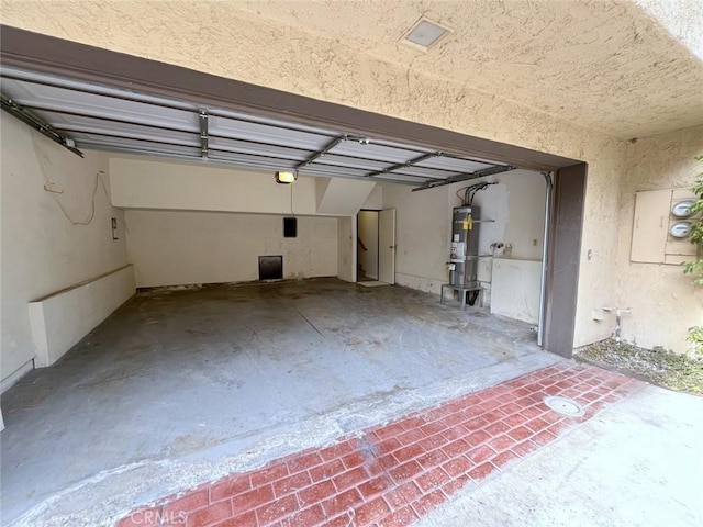 garage featuring a garage door opener and secured water heater