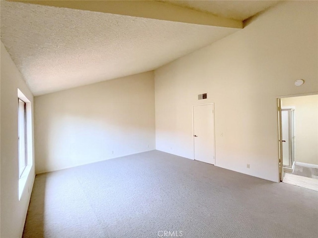 spare room with carpet flooring, high vaulted ceiling, and a textured ceiling