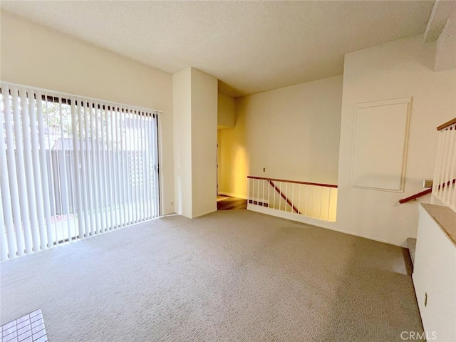 unfurnished room featuring a textured ceiling