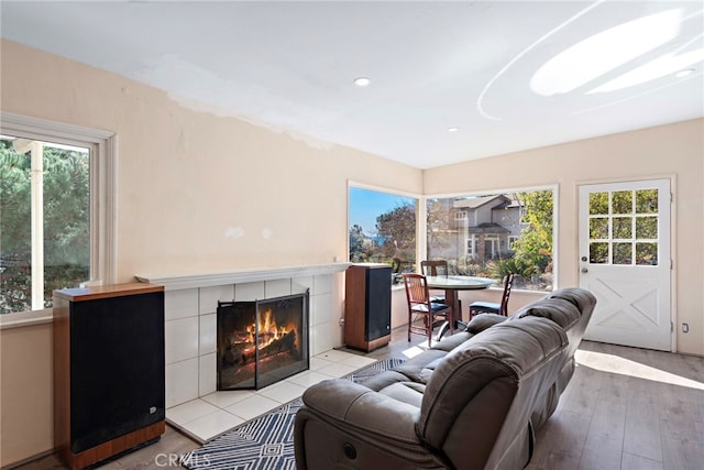 living room with a fireplace and light wood-type flooring