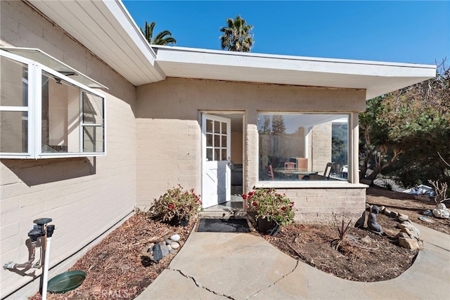 view of exterior entry featuring a patio