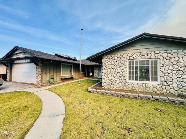 view of property exterior featuring a garage and a lawn