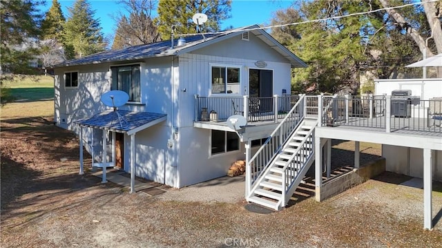 back of property featuring a deck