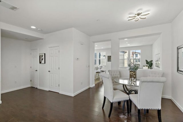 dining space with dark wood-type flooring