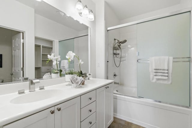 bathroom featuring enclosed tub / shower combo and vanity