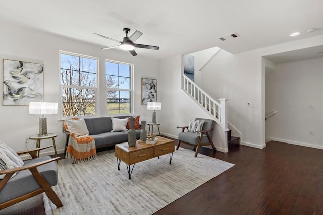 living room featuring dark hardwood / wood-style floors and ceiling fan