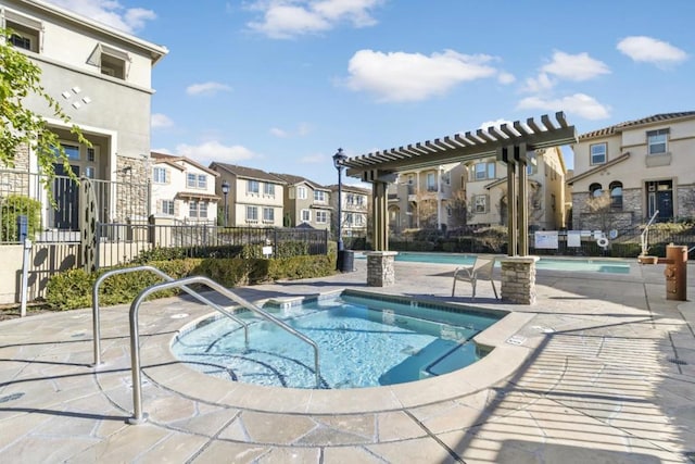 view of swimming pool featuring a pergola, a community hot tub, and a patio area