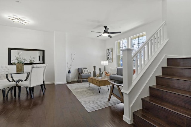 living room featuring ceiling fan and dark hardwood / wood-style flooring