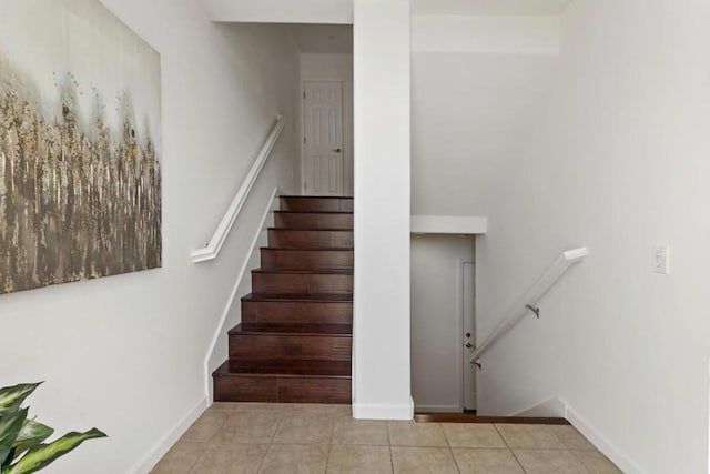 stairway with tile patterned flooring