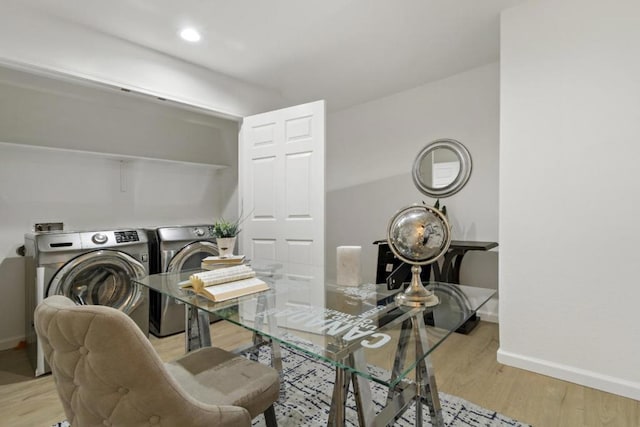 office featuring separate washer and dryer and light hardwood / wood-style flooring