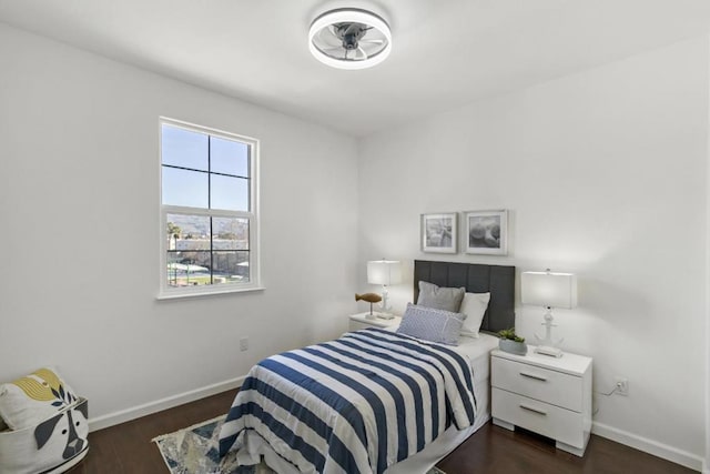 bedroom with dark hardwood / wood-style floors