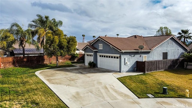 view of front of property featuring a garage and a front lawn