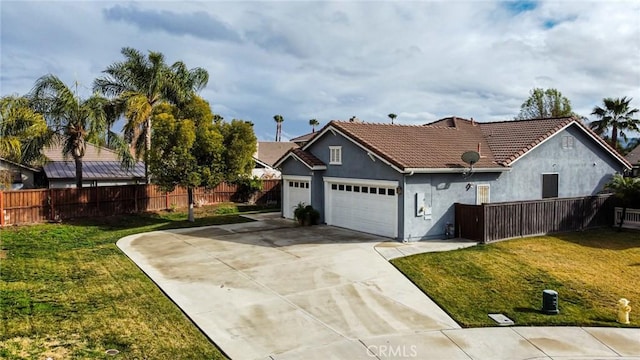 view of front of property featuring a garage and a front lawn