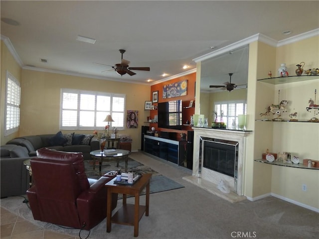 living room with crown molding, light carpet, a wealth of natural light, and a high end fireplace