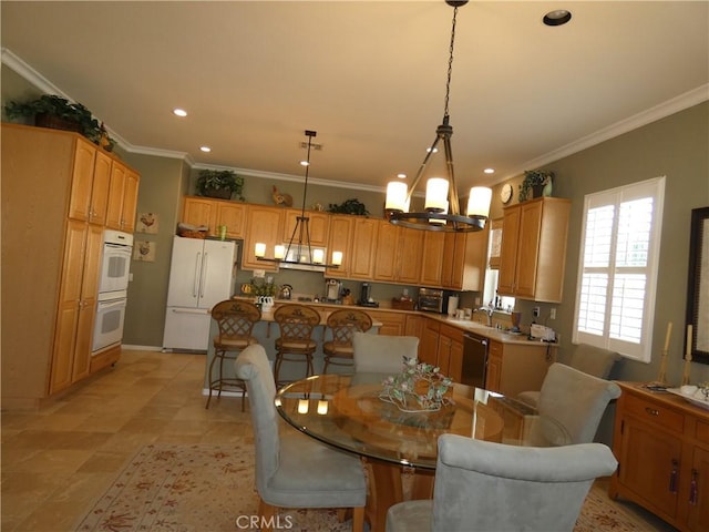 dining area featuring crown molding and sink