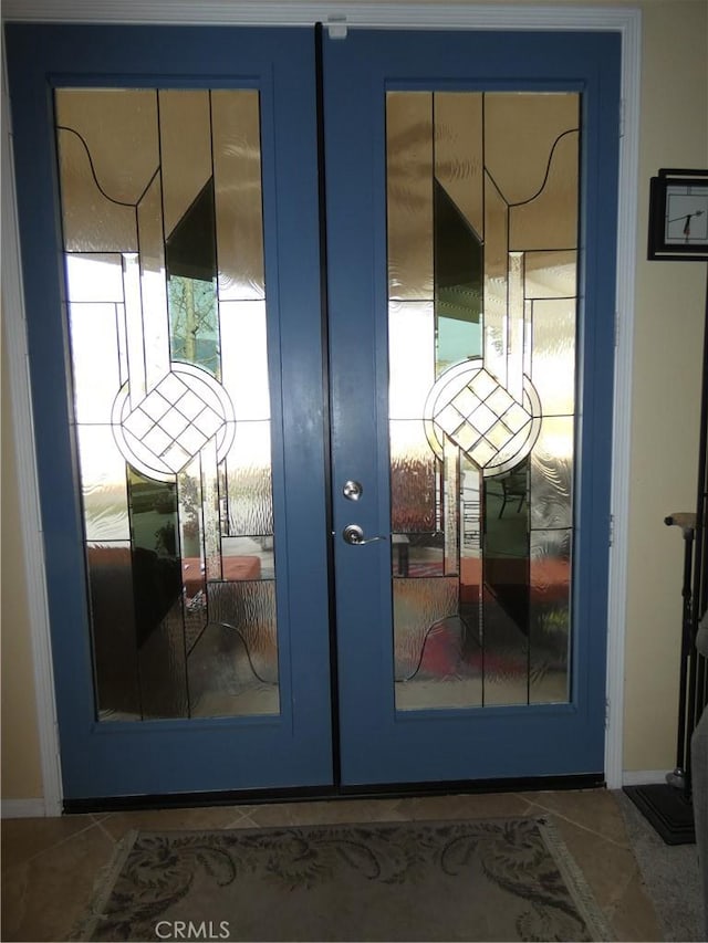 entryway with dark tile patterned floors