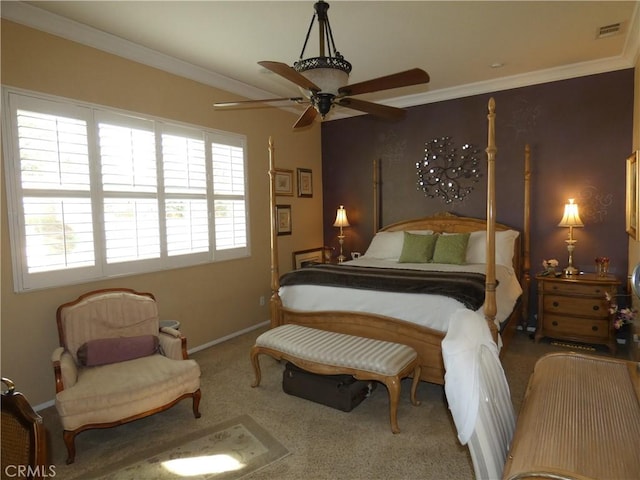 carpeted bedroom with ornamental molding and ceiling fan