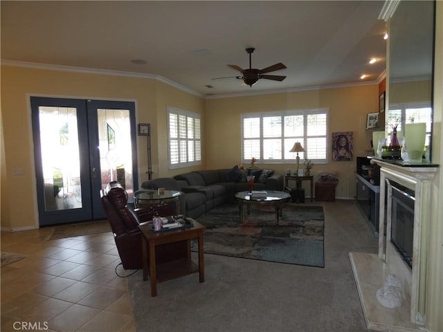 living room featuring light tile patterned floors, ornamental molding, french doors, and ceiling fan