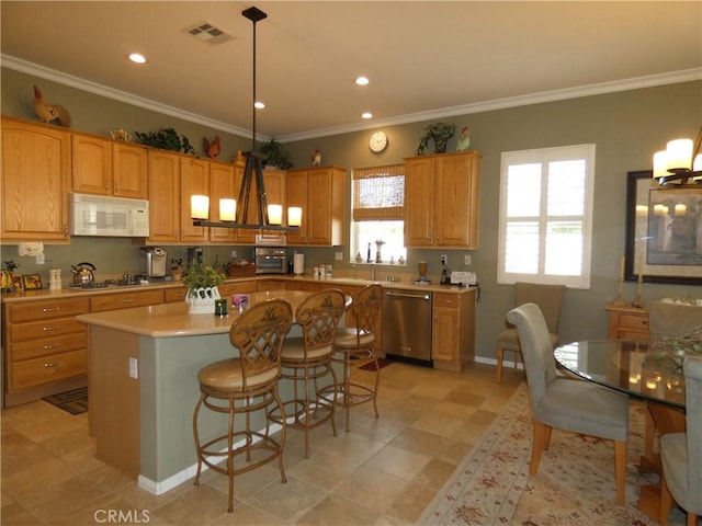 kitchen with pendant lighting, ornamental molding, stainless steel appliances, and a center island