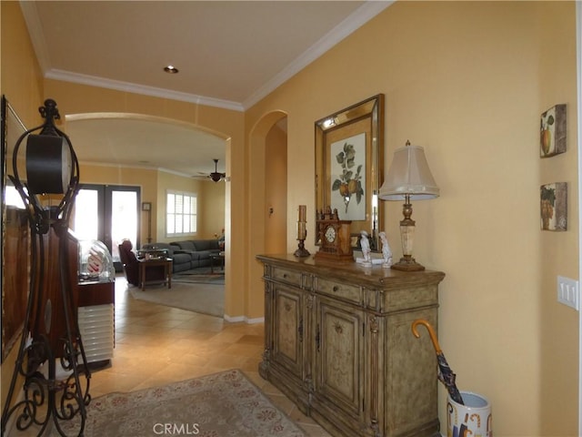 hall with crown molding and light tile patterned flooring