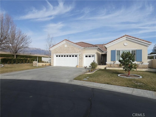 view of front facade with a mountain view, a garage, and a front yard