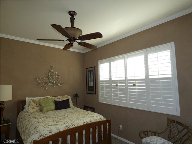 bedroom with ceiling fan and ornamental molding