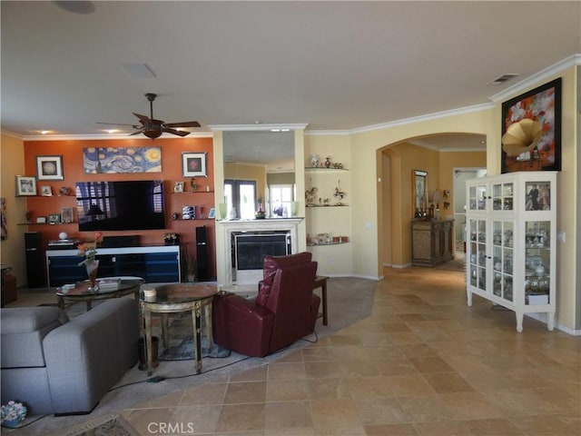 living room with ornamental molding and ceiling fan