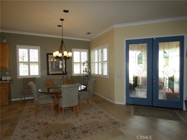 tiled dining room featuring a notable chandelier, ornamental molding, and french doors