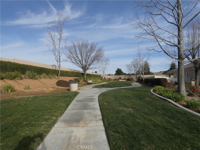 view of home's community with a lawn