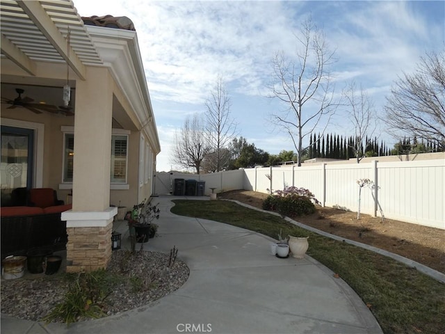 exterior space with ceiling fan and a patio area