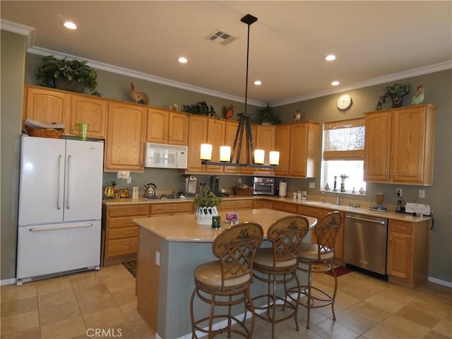 kitchen with a kitchen island, decorative light fixtures, a breakfast bar area, crown molding, and white appliances