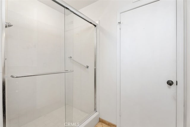 bathroom featuring a shower with door