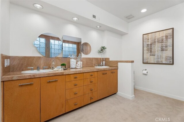 bathroom featuring vanity, decorative backsplash, and toilet