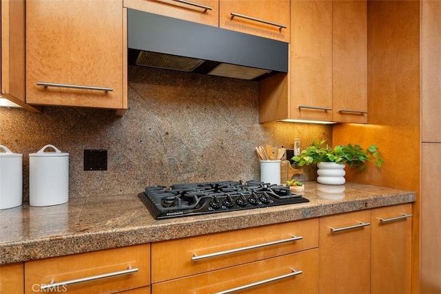 kitchen with extractor fan, backsplash, and black gas cooktop