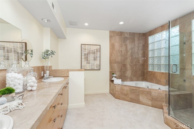 bathroom with vanity and separate shower and tub