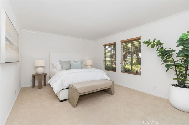 bedroom featuring crown molding and light colored carpet