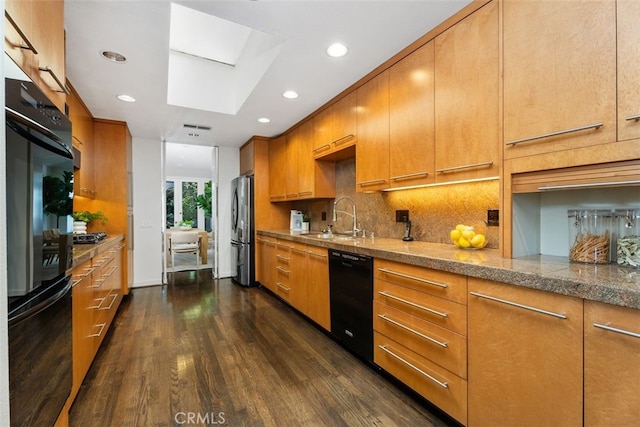 kitchen with sink, stainless steel refrigerator, dark hardwood / wood-style floors, black dishwasher, and tasteful backsplash