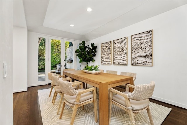 dining room featuring lofted ceiling, dark hardwood / wood-style floors, and french doors