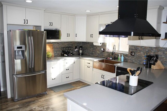 kitchen with tasteful backsplash, black appliances, white cabinets, and island exhaust hood