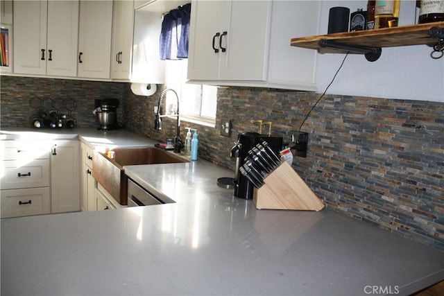 kitchen with white cabinetry, sink, and decorative backsplash