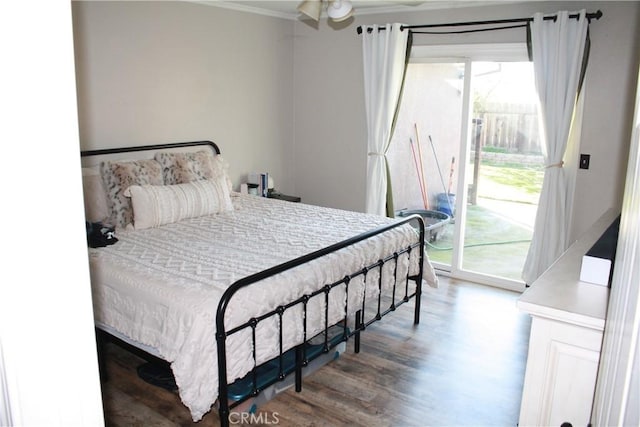 bedroom with hardwood / wood-style flooring, crown molding, and access to exterior