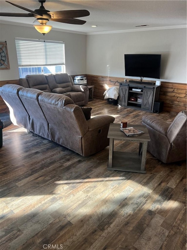 living room with ornamental molding, dark hardwood / wood-style floors, and ceiling fan