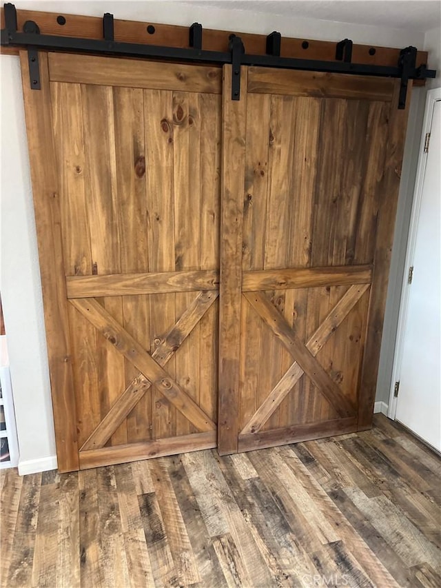 interior details featuring hardwood / wood-style flooring and a barn door