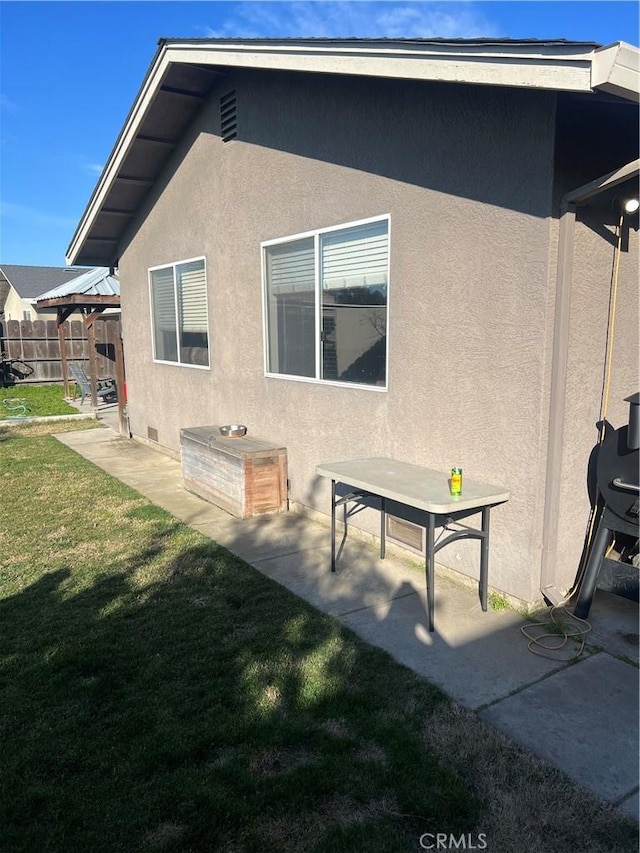 rear view of property featuring a gazebo, a yard, and a patio