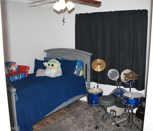 bedroom featuring ceiling fan and dark hardwood / wood-style floors