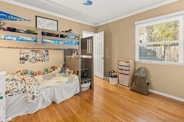 bedroom with hardwood / wood-style flooring and crown molding